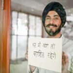 a man holding a paper with Indian language showing the concept of how to speak Indian languages fluently